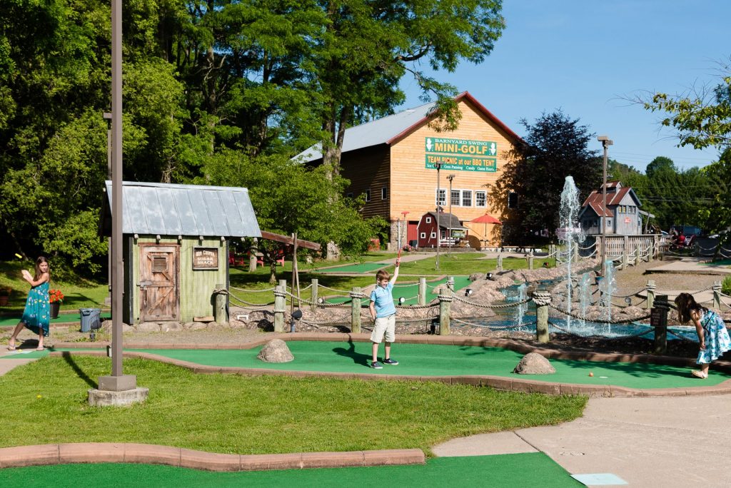 Children playing mini-golf at Barnyard Swing in Cooperstown, NY