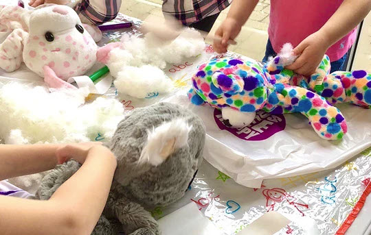children stuffing animals at DIY animal activity station